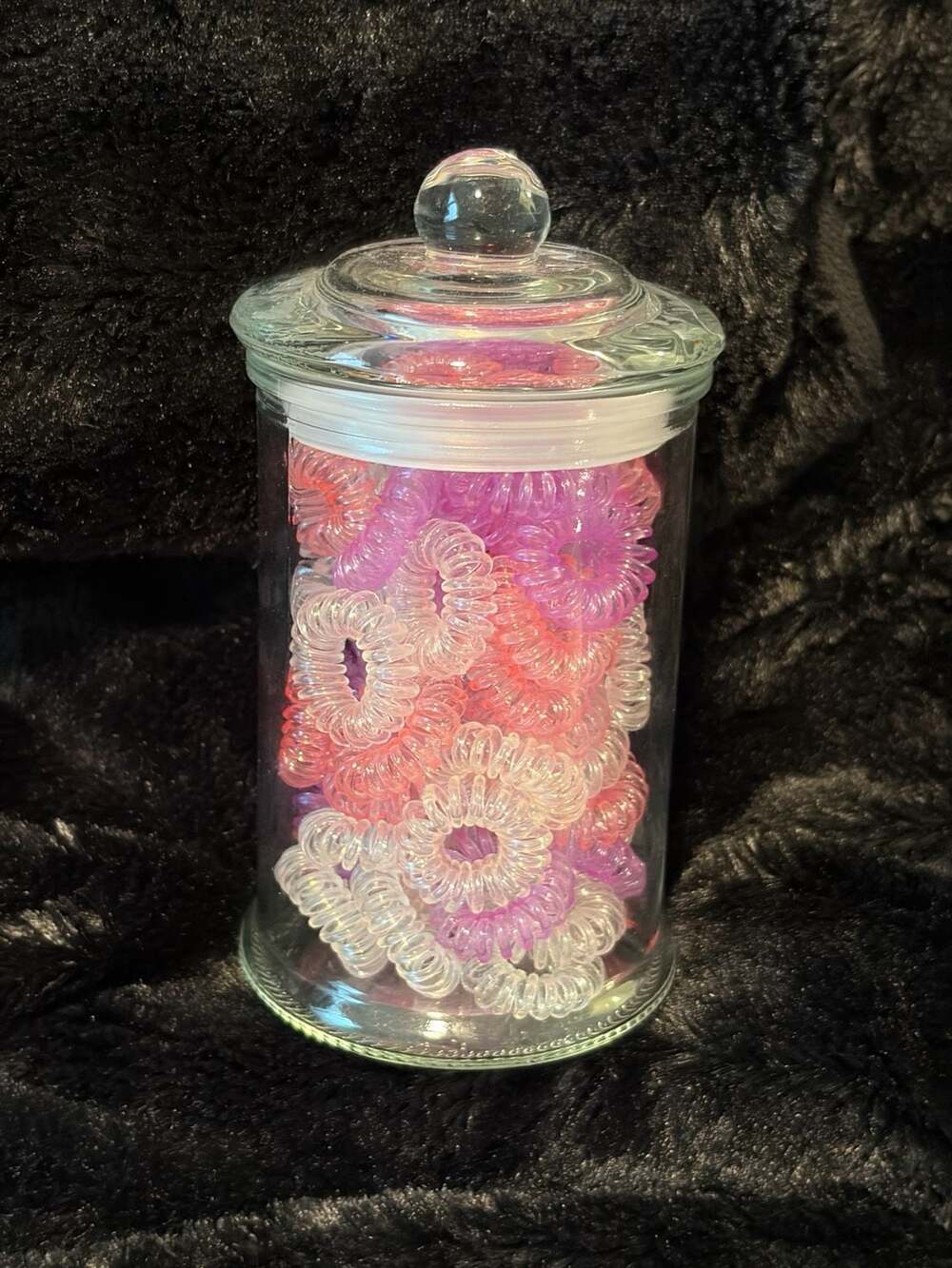 Clear Glass Storage Jar Filled with Pink and Purple Spiral Hair Coils